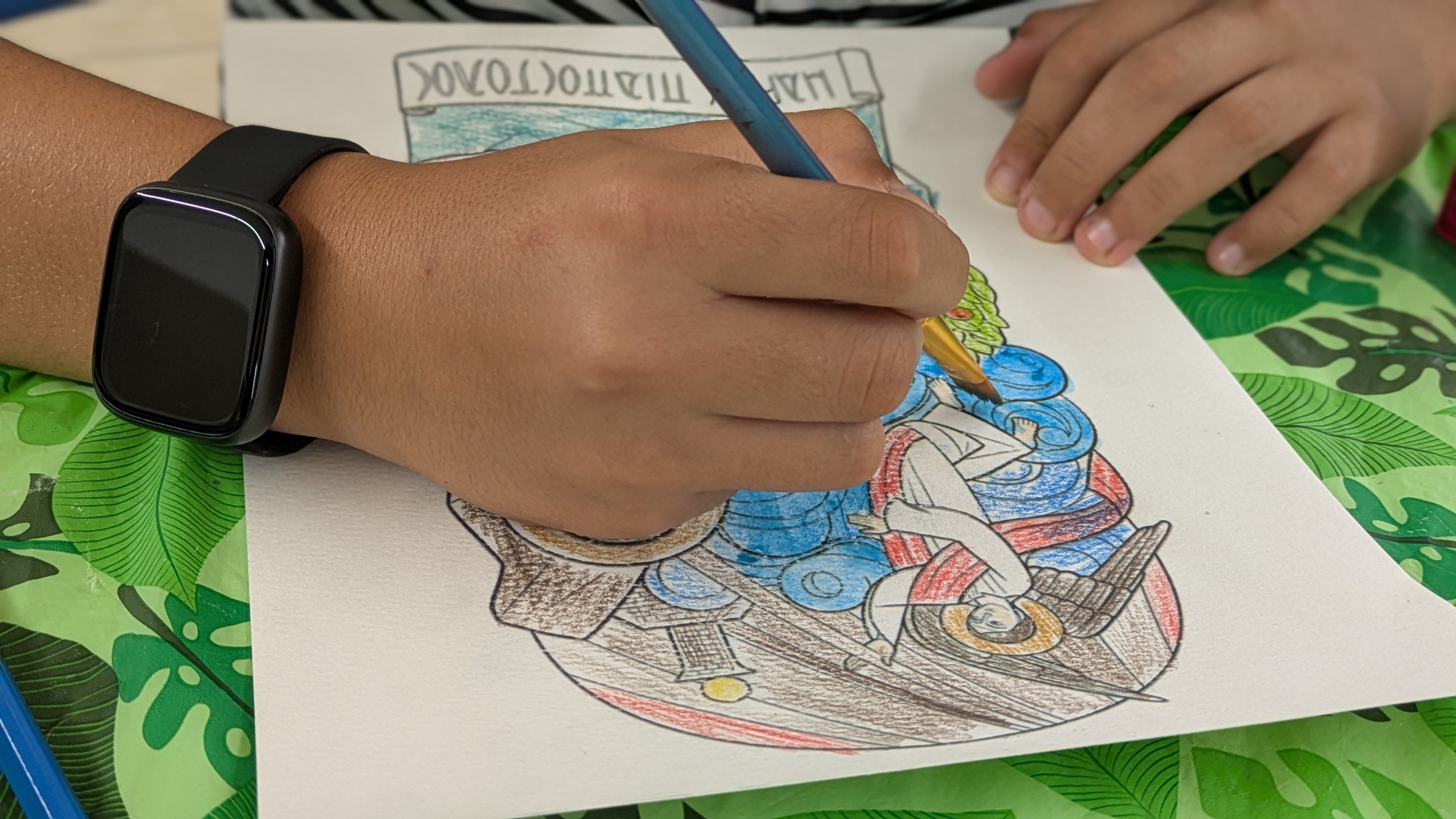 Young student coloring and painting an icon of Saint Mark